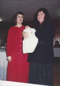Baptism day in the arms of Luanne, a Morton mother in faith